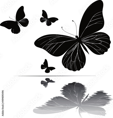 Elegant black butterflies gracefully fluttering above a reflective surface.