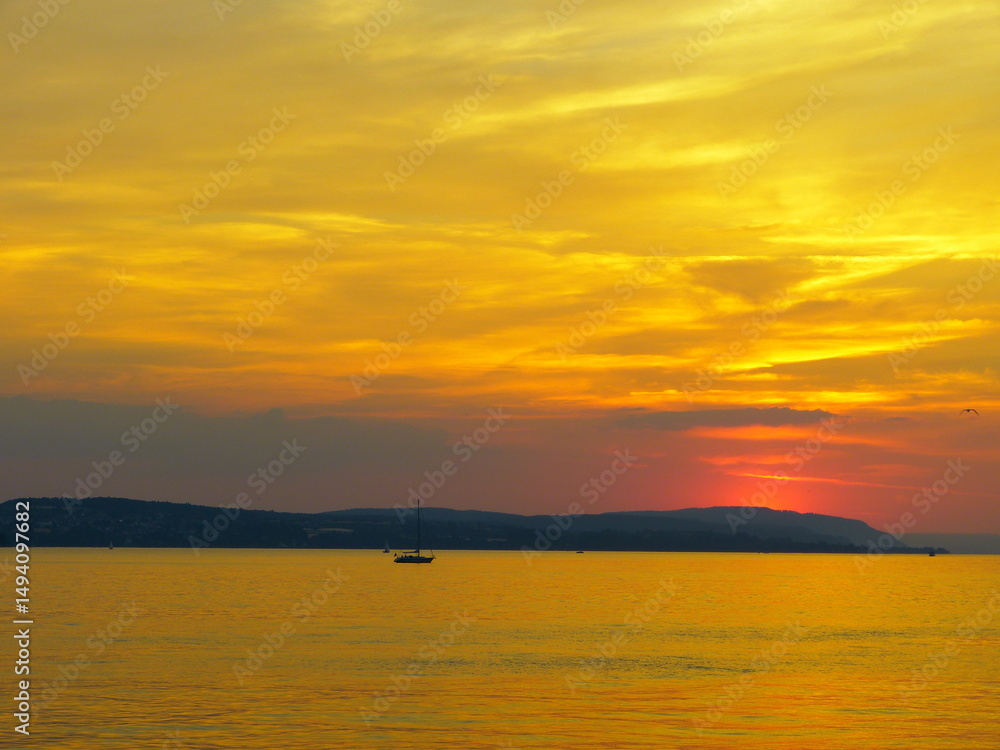 Colorful sunset at lake Constance, view from Meersburg. Sunset in the summer at lake Constance. Bodensee, Germany. Colorful sunset at lake Constance, view from Meersburg. Sunset in the summer at lake Constance. Bodensee, Germany.
