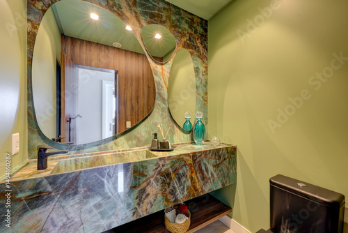 Modern and elegant bathrooms in a luxury apartment, featuring marble finishes, large mirrors, glass showers, and natural lighting