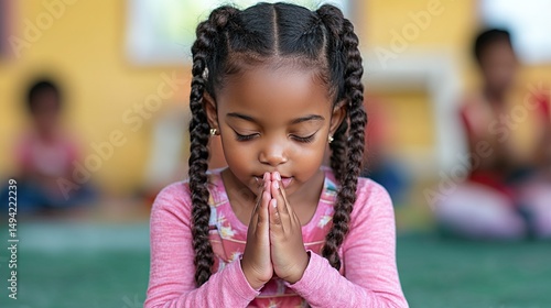Girl praying with classroom, school, and peace.