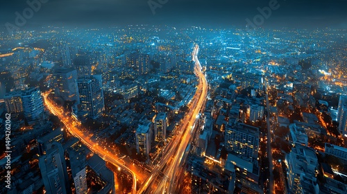Aerial night view of a city skyline with illuminated streets and buildings.