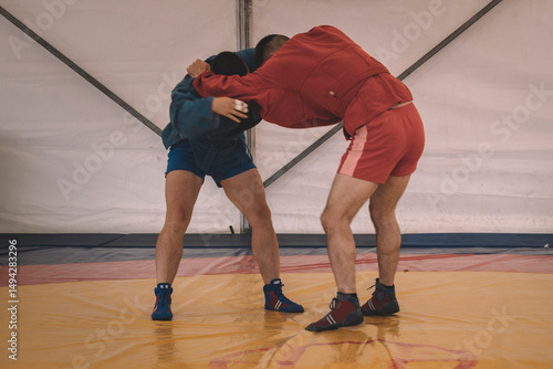 Sparring training of two athletic fighters in the gym. Martial arts, Wrestling photo