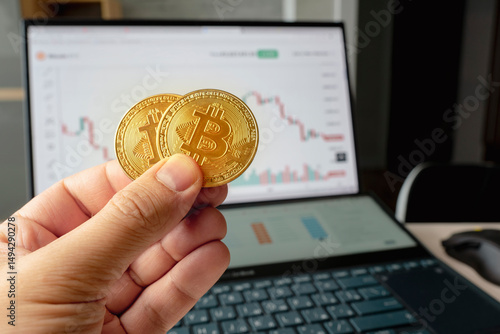 Hand holding golden coin crypto currency stock trade graph background new invest market. the concept of the fall of the cryptocurrency market