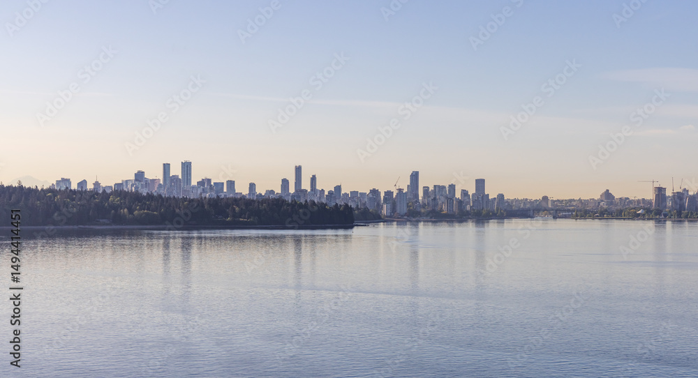 Fototapeta premium Panoramic View of Vancouver Skyline in BC with Water Reflecting Morning Light