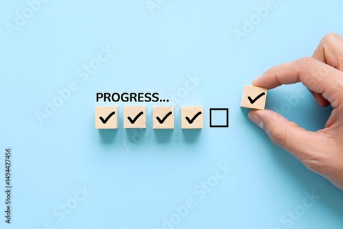 Checklist and task progress tracking concept. A hand placing the final checkmark on wooden blocks in a progress bar, task completion, productivity, goal setting, and efficient project management.