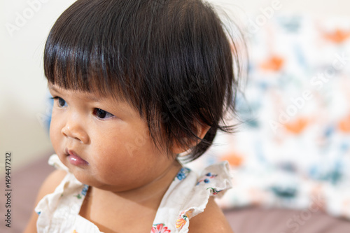 One year old asian baby girl portrait indoor setting lifestyle close-up natural expression