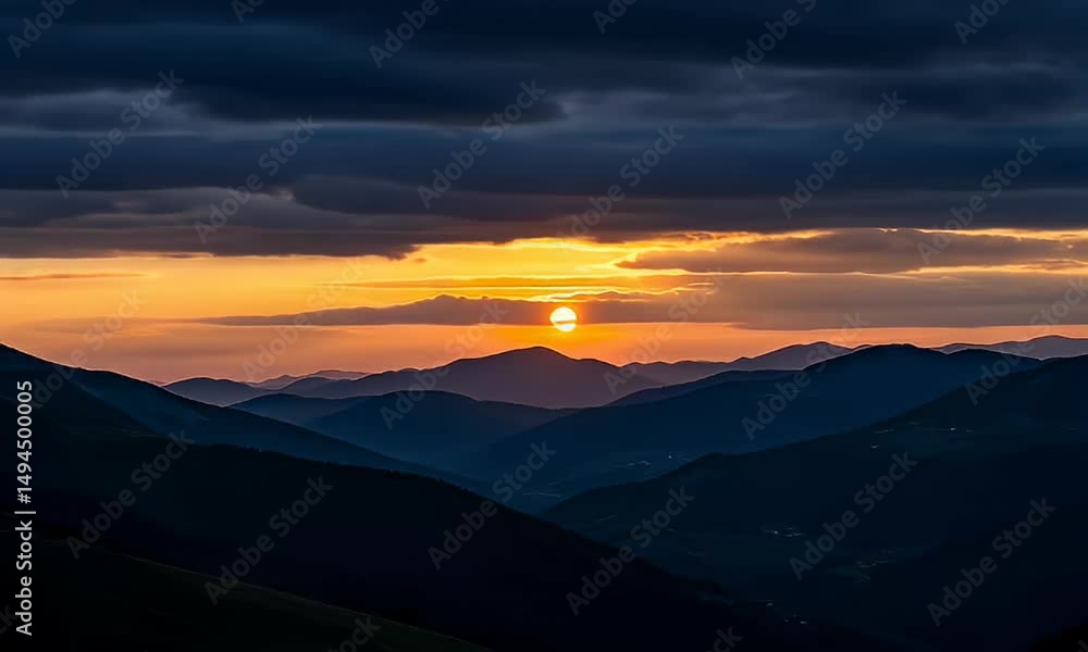 Layers of mountains under a dramatic sunset sky full of dark, textured clouds Layers of mountains under a dramatic sunset sky full of dark, textured clouds