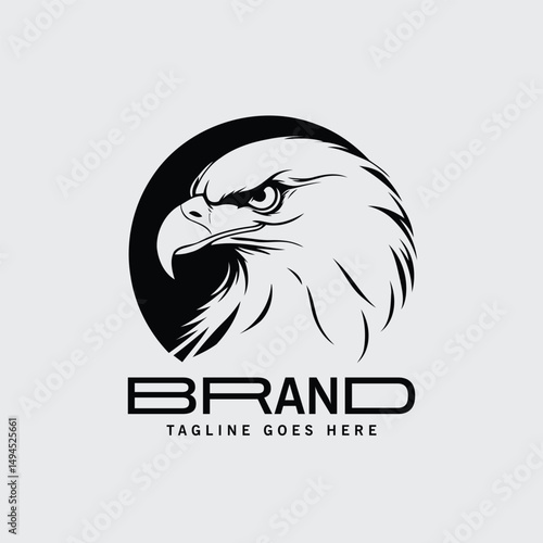 Black and white eagle logo design with company branding. Bold, powerful profile view of an eagle head against a circle with a modern text design for a company logo.