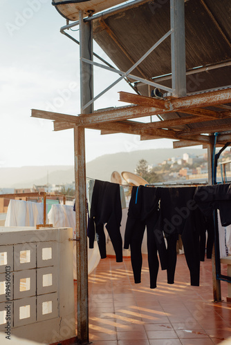 Wetsuits Drying on a Rooftop After Surfing – Awrir, Morocco