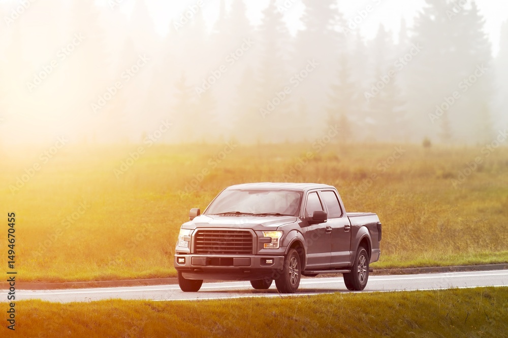 Fototapeta premium Misty rural road drive with pickup truck