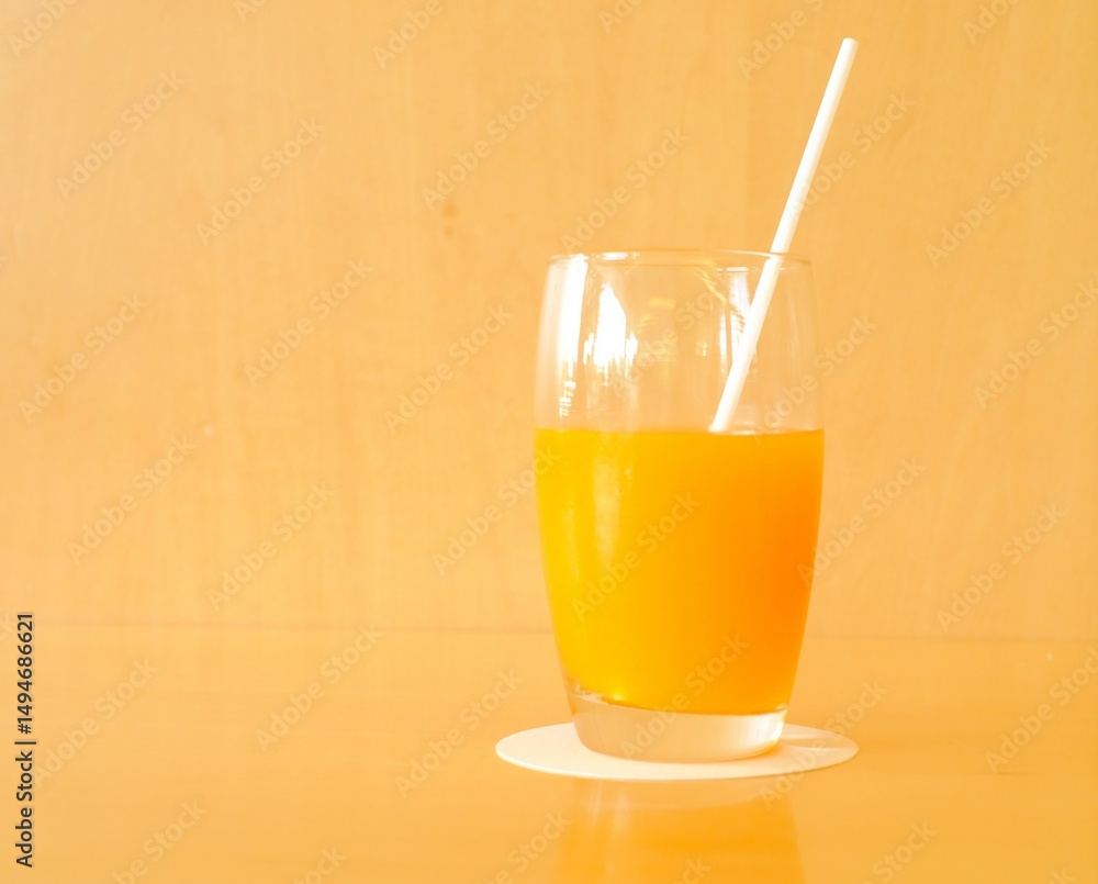 Fototapeta premium a glass of orange juice on the table 