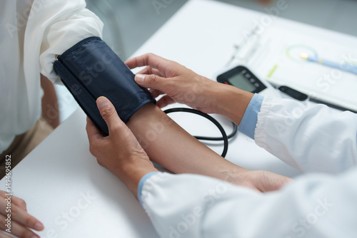 Tableau sur toile Medical professional checking patient's blood pressure