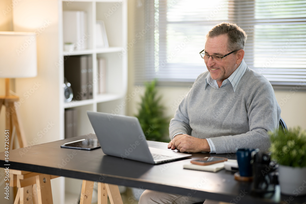Businessman discussing work via video conference at his desk. Businessman discussing work via video conference at his desk.