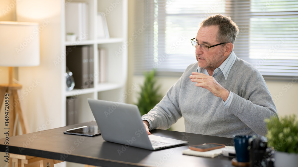 Fototapeta premium Businessman discussing work via video conference at his desk.