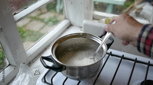 Wallpaper Mural Stirring the cooking rice in the pan. Torontodigital.ca