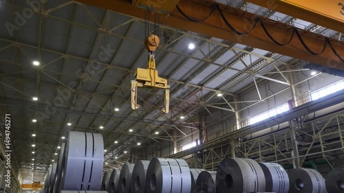 lifting a large part with a crane at a factory