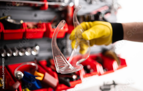 Mechanic Holding A Protective Googles In Hand