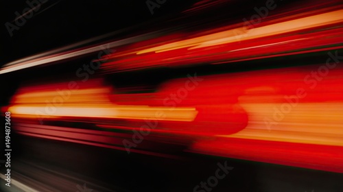 Dynamic motion blur of vibrant red and orange light streaks.