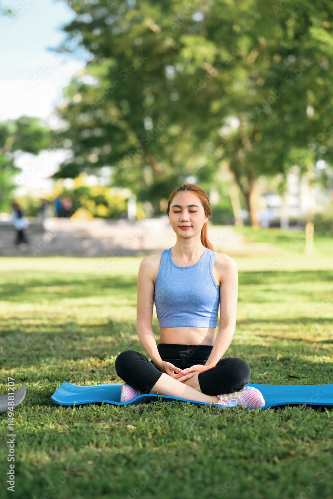 Woman practicing meditation and deep breathing on a yoga mat in a natural environment Woman practicing meditation and deep breathing on a yoga mat in a natural environment
