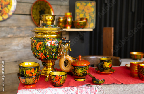 Billede på lærred Samovar and traditional tea equipment with vivid Khokhloma painting on a table