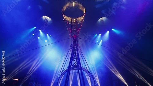 Circus equipment with colorful spotlights. Rays of light in the circus arena. Wheel of death.