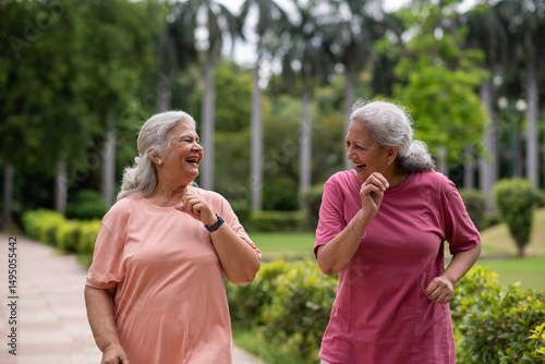 Indian happy senior women jogging in the park.