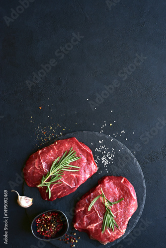 Raw organic marbled beef steak with ingredients for cooking . Top view with copy space.