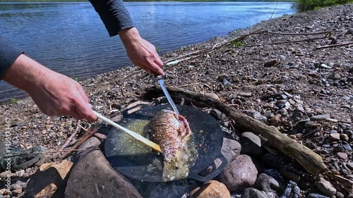 Cooking food over a fire outdoors