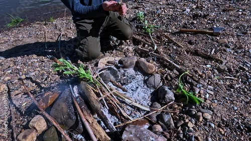 Break sticks and put them on the fire