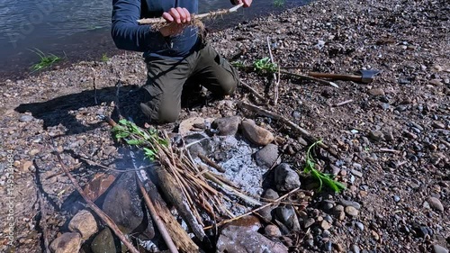 Break sticks and put them on the fire