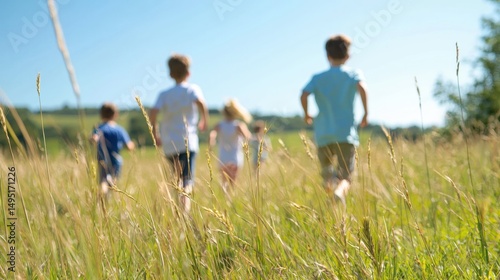 Children joyfully running through a sunny summer field, blurred motion, grass blades in focus.
