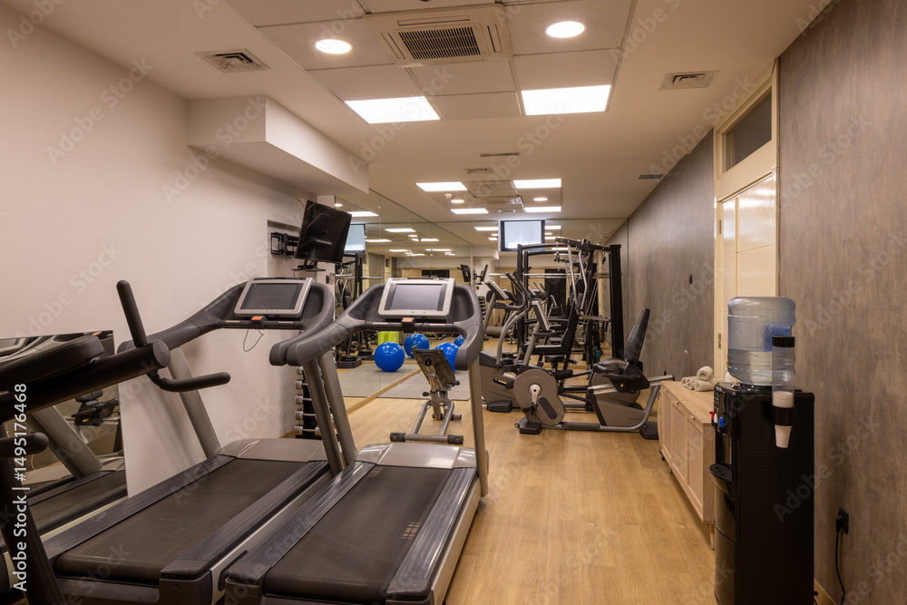 Fototapeta premium Modern fitness gym with equipment and mirrors
