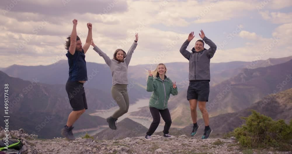 Four friends celebrate their outdoor adventure by exuberantly jumping with a scenic mountain and lake landscape in the background. Perfect moment of friendship and freedom. Four friends celebrate their outdoor adventure by exuberantly jumping with a scenic mountain and lake landscape in the background. Perfect moment of friendship and freedom.