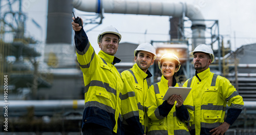 Photos Male and female industrial engineers wearing hard hats talk to collaborate on new project