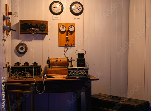 Photography Old radio communication equipment, typewriter, headphones, and clocks showing lo