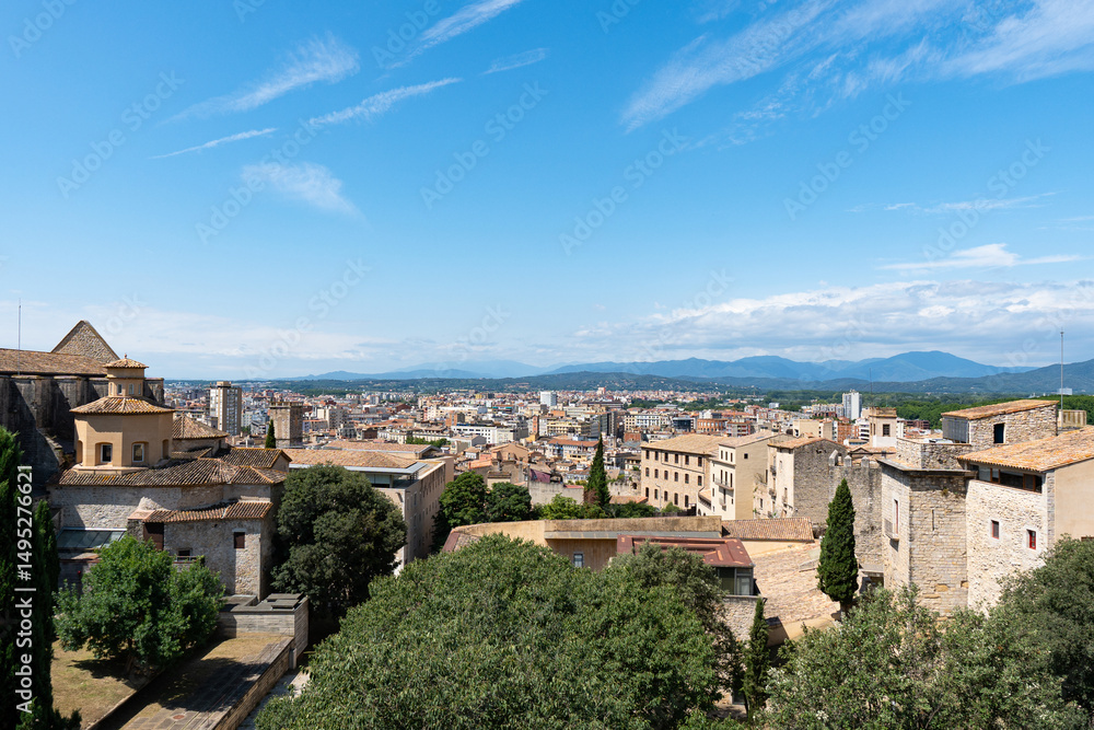Fototapeta premium Landscape of Girona from the distance with mountains in the background on a nice day of summer
