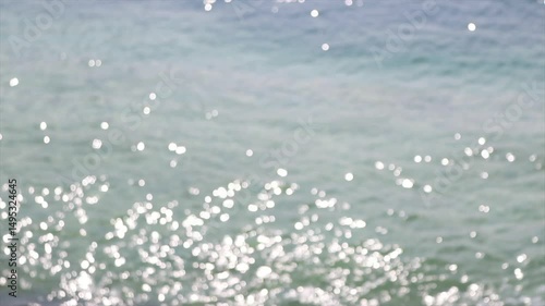 Sparkling waters reflect sunlight in calm coastal setting during the day