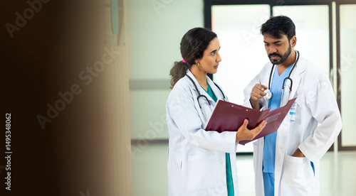 teamwork concept : Two professional doctors meeting discussing diagnosis, checking test results in clinic. Medical staff, healthcare. Diverse people Indian and hispanic latin doctor