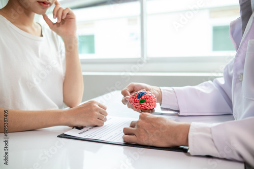 doctor is asking about patient information and symptoms to diagnose brain diseases before consulting patient and diagnosing correct treatment. doctor is consulting patient about brain problems.