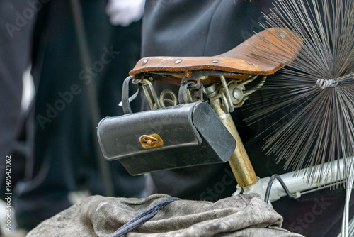 Quadro su tela Traditional chimney sweep equipment mounted on a bicycle – visible chimney brush, leather seat, and tool bag