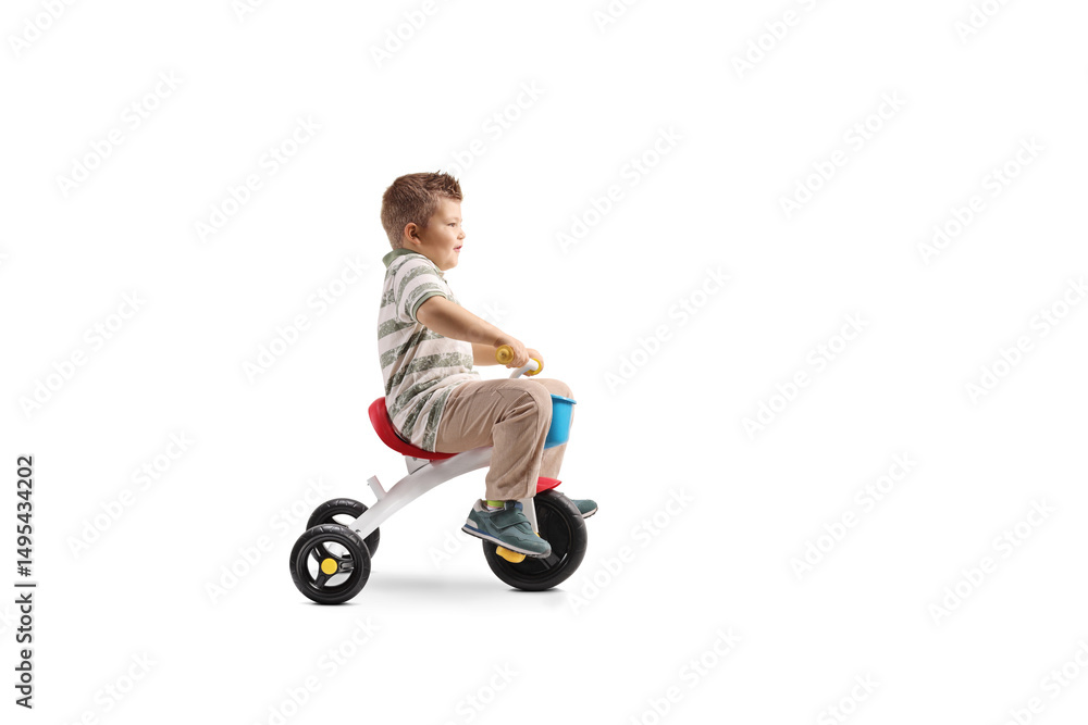 Full length profile shot of a boy riding a tricycle Full length profile shot of a boy riding a tricycle
