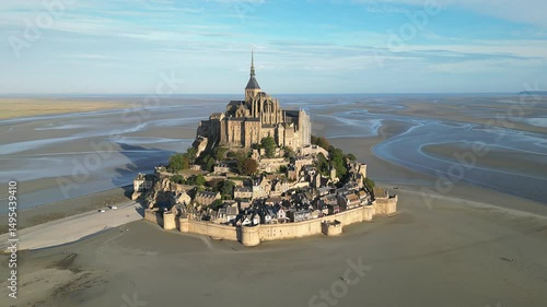Drone view of Mont-Saint-Michel Abbey nestled in expansive tidal landscape with rural land in France