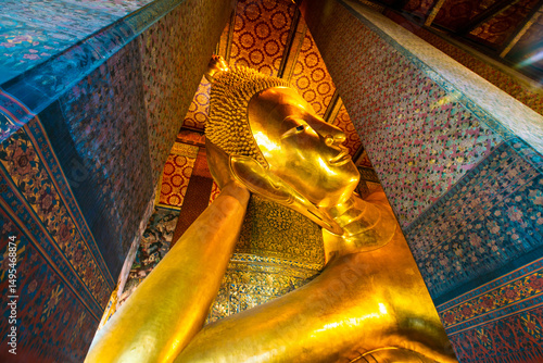 Photography Golden big reclining buddhist statue in temple