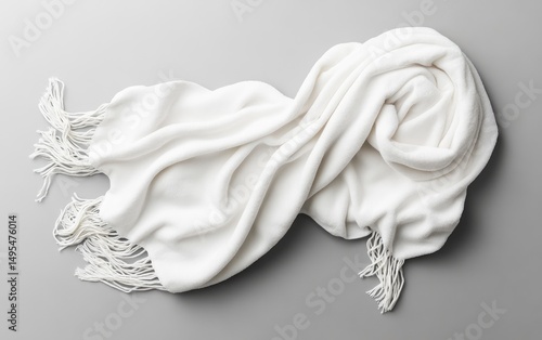 Soft, white shawl draped on gray surface