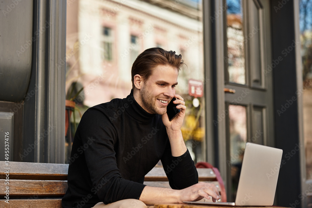 Handsome man enjoying a walk while engaged in a phone conversation Handsome man enjoying a walk while engaged in a phone conversation