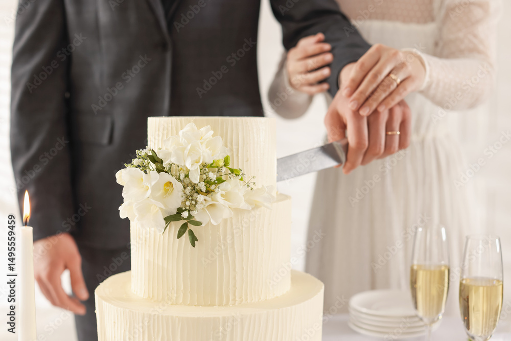 Newlyweds cutting wedding cake together indoors, closeup Newlyweds cutting wedding cake together indoors, closeup