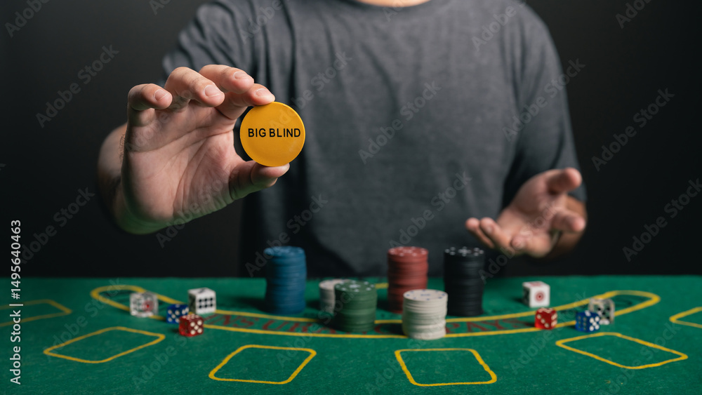 Close-Up of a Person Holding a Casino Chip Marked as Big Blind While Playing Poker at a Green Felt Poker Table with Various Chips and Dice Close-Up of a Person Holding a Casino Chip Marked as Big Blind While Playing Poker at a Green Felt Poker Table with Various Chips and Dice