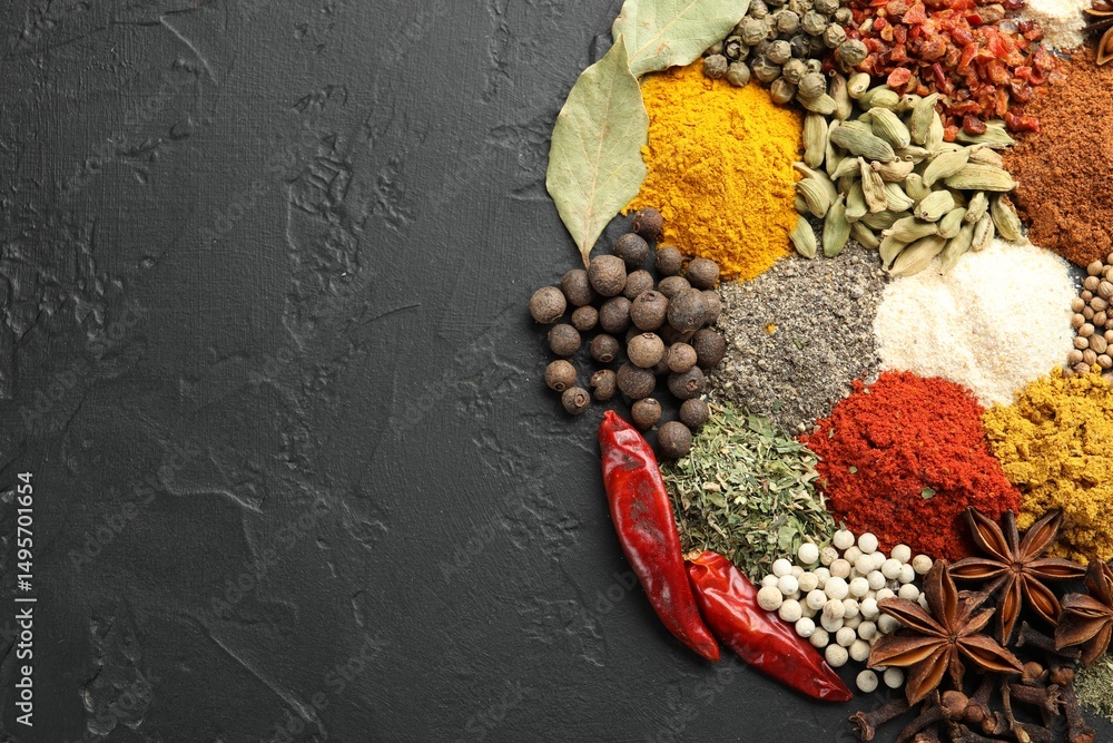 Fototapeta premium Different aromatic spices on grey table, top view. Space for text