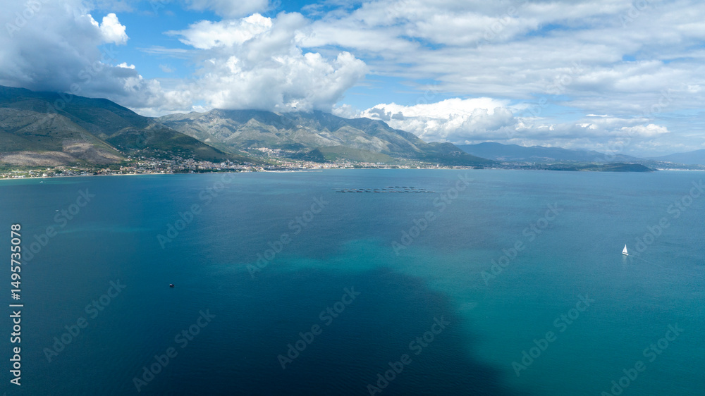 Naklejka premium Aerial view of mountains of the Lazio coast in the province of Latina, Italy. The mountains overlook the Mediterranean Sea on a cloudy day.