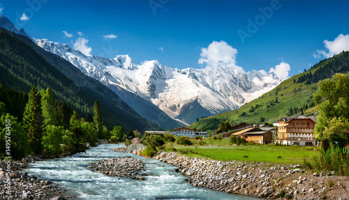 mountain village nestled in a valley with a rushing river snow capped peaks in the background